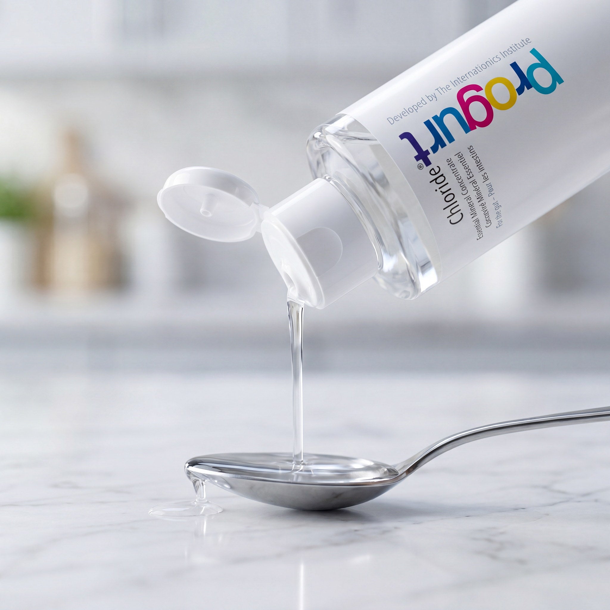 Chloride inside — clear ionic mineral liquid, a teaspoon fill on marble