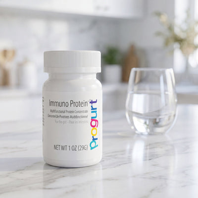 Immuno Protein — sealed jar on marble with a glass in soft bokeh