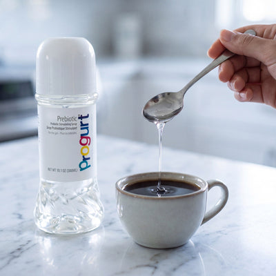 Prebiotic inside — amber syrup, a teaspoon stirred into coffee